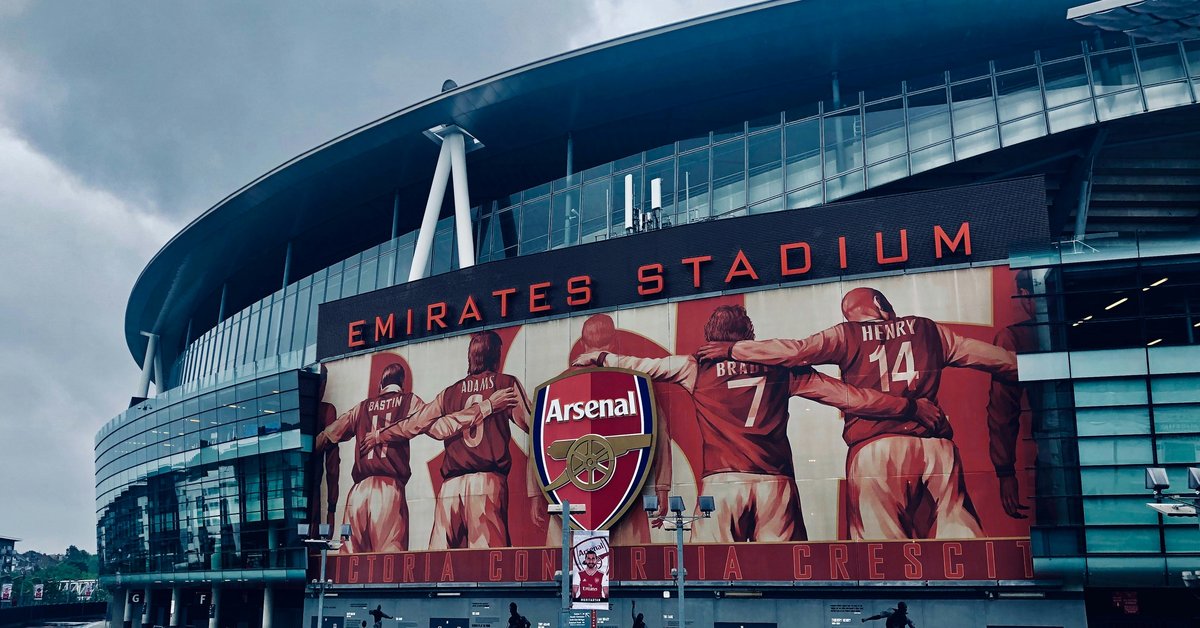 Emirates Stadium exterior with Arsenal players mural - best football betting sites UK